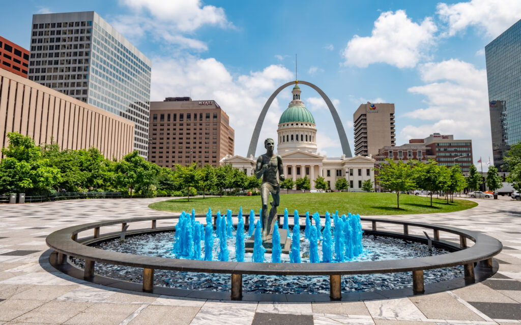 Blue water fountain with Runner Statue at Kiener Plaza Park in St. Louis