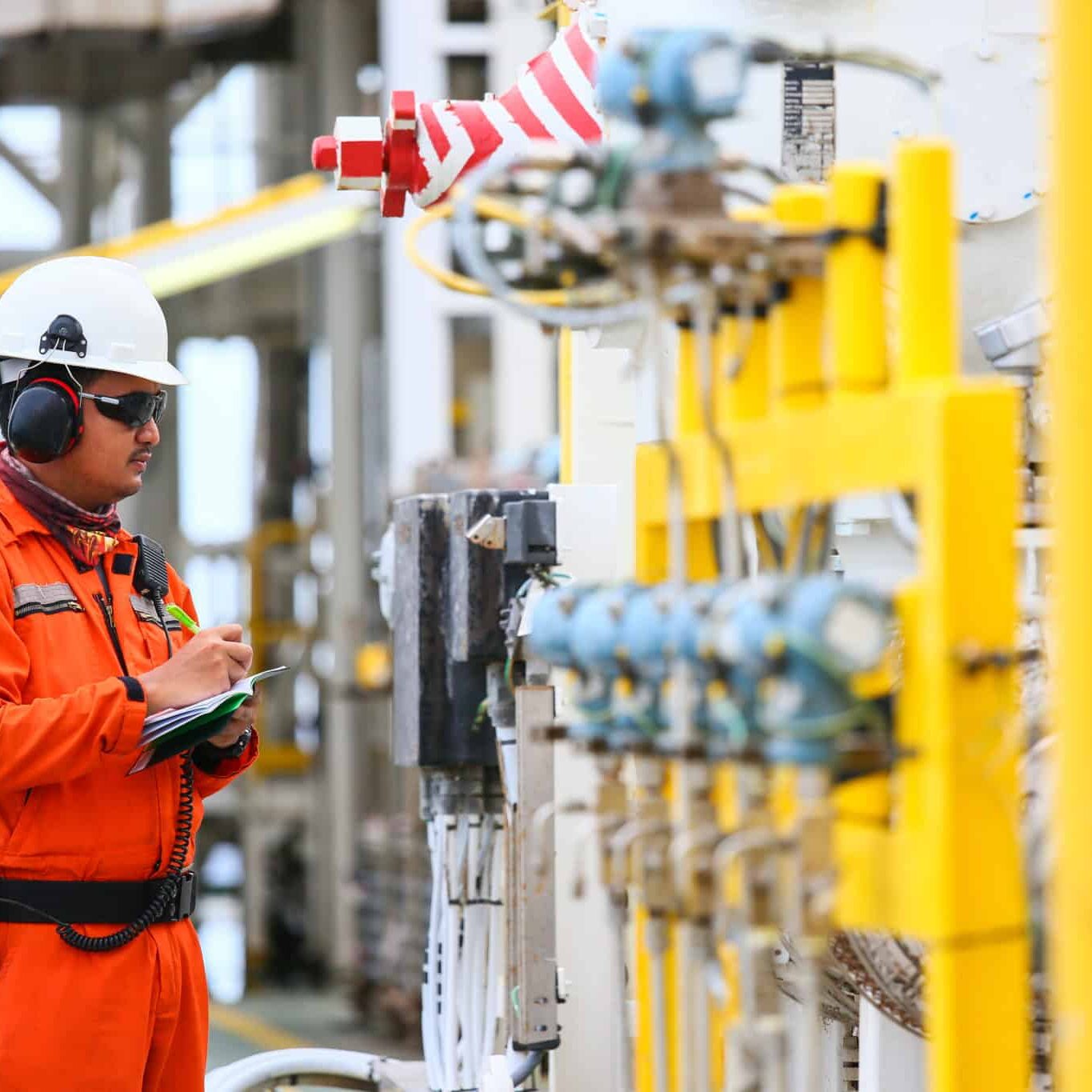 operator recording operation of oil and gas process at oil and r